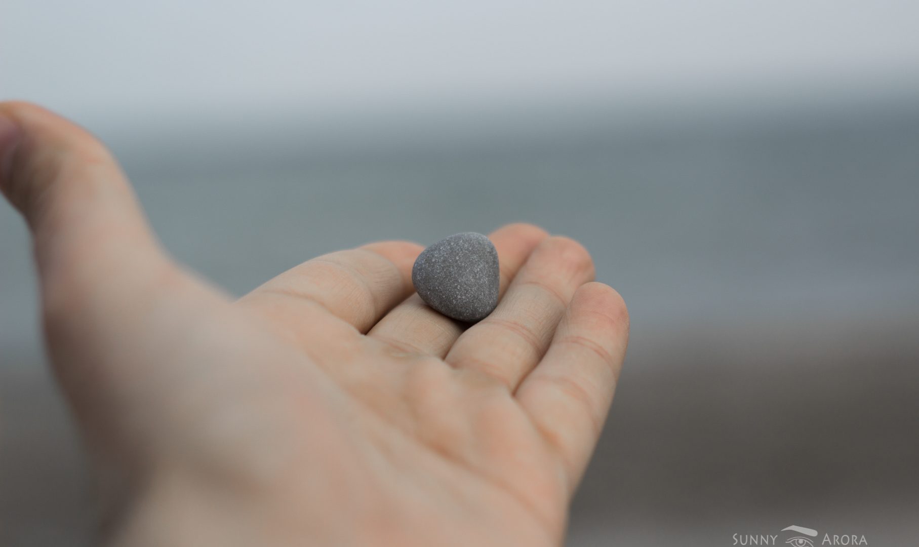 close up of hand with a stone on its fingers